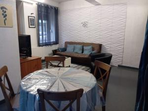 a living room with a table and a couch at Studio Miribel in Miribel