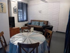a living room with a table and a couch at Studio Miribel in Miribel