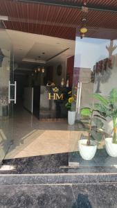 a glass window of a store with potted plants at Hotel Manglam in Kota
