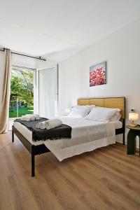 a bedroom with a large bed and a large window at Il Papavero, raffinato, accogliente, lussuoso appartamento in Santo Stino di Livenza +21 photos
