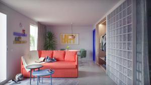 un soggiorno con un divano rosso e un tavolo di Coral Star Hotel a Baia di Sant'Antoni