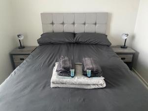 a bed with two towels and two glasses on it at Pennethorne Apartment in Clooney Park