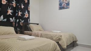 a room with two beds and a curtain with flowers at EcoHill Serenity Suites in Semenyih +20 photos