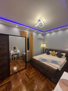 a bedroom with a bed with a blue light on the ceiling at Luxusvilla im Herzen von Baden in Baden +18 photos
