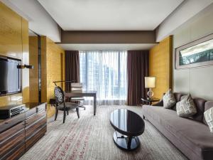 a living room with a couch and a table at Sofitel Guangzhou Sunrich - Free Shuttle Bus to Canton Fair Complex & Overseas Buyer Registration Services during Canton Fair Period in Guangzhou
