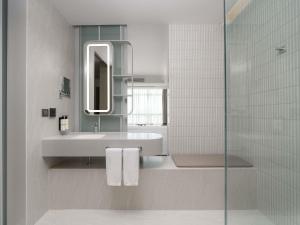 a bathroom with a sink and a mirror and a shower at Pullman Bangkok King Power in Bangkok +157 photos