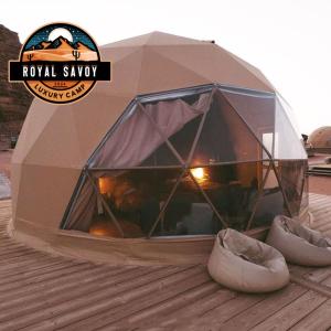 a tent with a pair of shoes in front of it at ROYAL SAVOY lUXURY CAMP in Wadi Rum