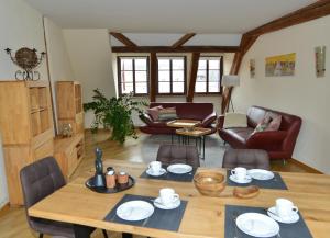 a living room with a wooden table and chairs at Ferienhaus mit 2 Schlafzimmern in Grimma nahe Mulderadweg in Grimma
