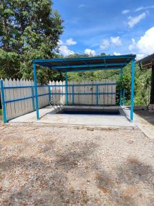 a blue bus stop with a blue canopy at Homestay Teratak Atas Bukit 