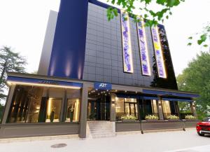 a building with a car parked in front of it at Art Hotel in Chişinău