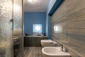 a bathroom with a toilet and a sink at Domus Elisae - Taormina in Taormina +3 photos