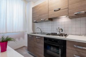 a kitchen with a stove and a sink at Domus Elisae - Taormina in Taormina
