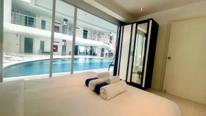 a bedroom with a bed and a swimming pool at Sunset Plaza Condominium in Ban Karon +211 photos