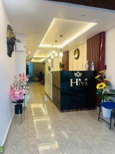 a lobby with a hna sign in the middle of a building at Hotel Manglam in Kota +5 photos