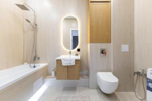 a bathroom with a toilet and a sink and a tub at Oasis Халал апартаменты возле самой большой Мечети Центральной Азии in Astana +44 photos