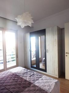 a bedroom with a bed and a large mirror at Holiday apartment Sombrero in Nea Peramos