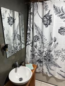 a bathroom with a sink and a shower curtain at La madriguera Matanzas in Navidad +58 photos