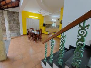 a living room with a staircase and a dining room at SHI's Chettinad Courtyard Villa a 3BHK near Adiyogi in Alāndurai