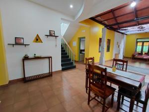 a dining room with a table and chairs and a staircase at SHI's Chettinad Courtyard Villa a 3BHK near Adiyogi in Alāndurai +57 photos
