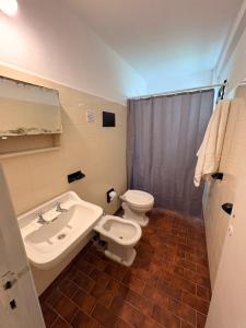 a bathroom with a sink and a toilet and a sink at Black Suites Pinamar in Pinamar +27 photos