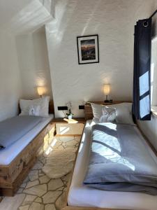 a room with two beds in a room at Chalet am Bachl 1 in Flattach