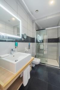 a bathroom with a sink and a shower and a toilet at Stay inn Hotel Gdańsk in Gdańsk
