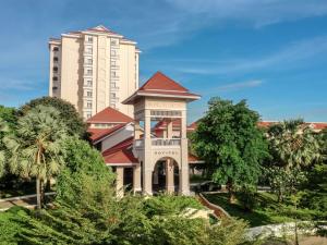 a large building in front of a building at Sofitel Phnom Penh Phokeethra in Phnom Penh