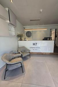 a store with two chairs and a counter in a room at H7 TLV in Tel Aviv