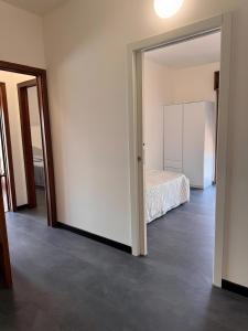 an empty room with a bed and a mirror at Casa Aris in Staranzano +9 photos