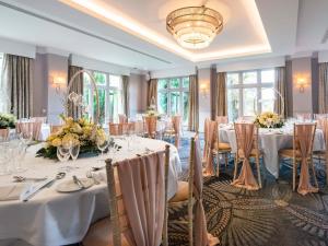 a banquet room with white tables and chairs at Mercure Blackburn Dunkenhalgh Hotel & Spa in Blackburn +171 photos