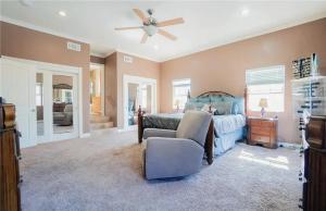 a bedroom with a bed and a ceiling fan at Three Bedroom Home with Guest Suite in San Pedro Peninsula Hospital Heliport +17 photos