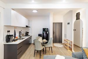 a kitchen and living room with a table and chairs at Westlands Oasis, Luxury Pool, Gym & Gaming Fun in Nairobi