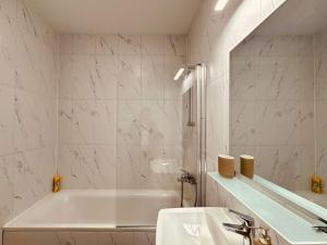 a white bathroom with a tub and a sink at Joy City Stay Forest 54-85 in Dumbrăviţa