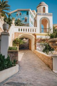 a house with an archway in front of it at Lotus Grand Apartment - Firework View, Sunset Town Phu Quoc in Phu Quoc