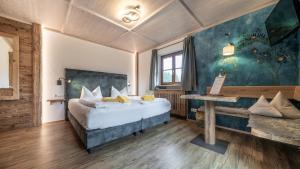 a bedroom with a bed and a table in a room at LandererMühle in Lenggries