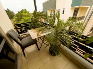 a balcony with a bench and a potted plant at Cozy One Bedroom Apartment with Fast Fibre Wifi, Netflix, Hot Showers, Furnished Kitchen in Kampala