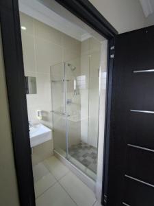 a bathroom with a shower and a sink at 33onBazley Hotel in Durban +34 photos
