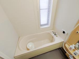 a white bath tub in a bathroom with a window at Seaside Villa Matsugaya - Vacation STAY 19447 in Sammu +52 photos