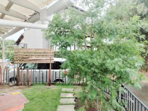 a porch with a bench and a white bus at Seaside Villa Matsugaya - Vacation STAY 19447 in Sammu