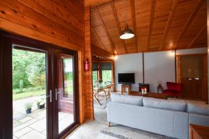 a living room with a couch and a television at Lyall Lodge in East Barcloy