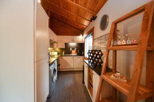a small kitchen with a washer and dryer at Lyall Lodge in East Barcloy