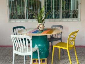 a table with chairs and a potted plant on it at Aonang Private Pink House 8 in Ao Nang Beach