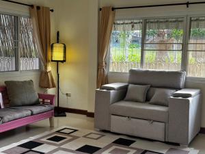 a living room with a couch and a chair at Aonang Private Pink House 8 in Ao Nang Beach +5 photos