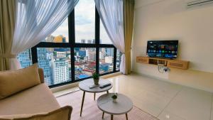 a living room with a couch and a large window at Eshue Designer Suites Majestic Residence in Kuala Lumpur