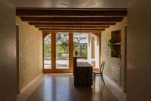 a kitchen with a table and a chair in a room at La Ghiandaia Farmhouse in Conegliano