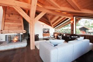 a living room with a couch and a fireplace at Chalet Les Praz - Chamonix All Year in Chamonix