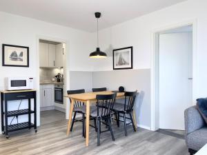 a kitchen and dining room with a table and chairs at Blankwasser 169 in Grömnitzerhagen