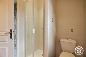 a shower stall in a bathroom with a toilet at La croix au roi in Landéhen