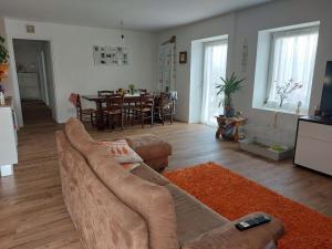 a living room with a couch and a dining room at Gemma del Lagorai in Torcegno