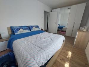 a bedroom with a bed with blue and white sheets at Gemma del Lagorai in Torcegno
